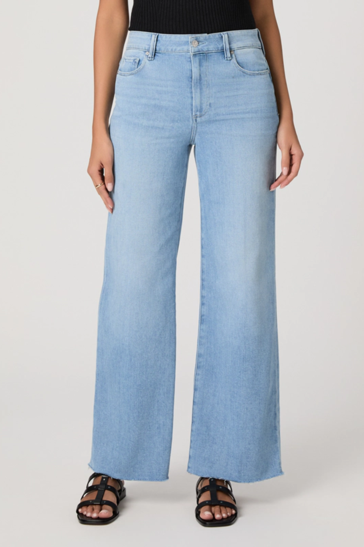 Light blue jeans worn by a person on a white background