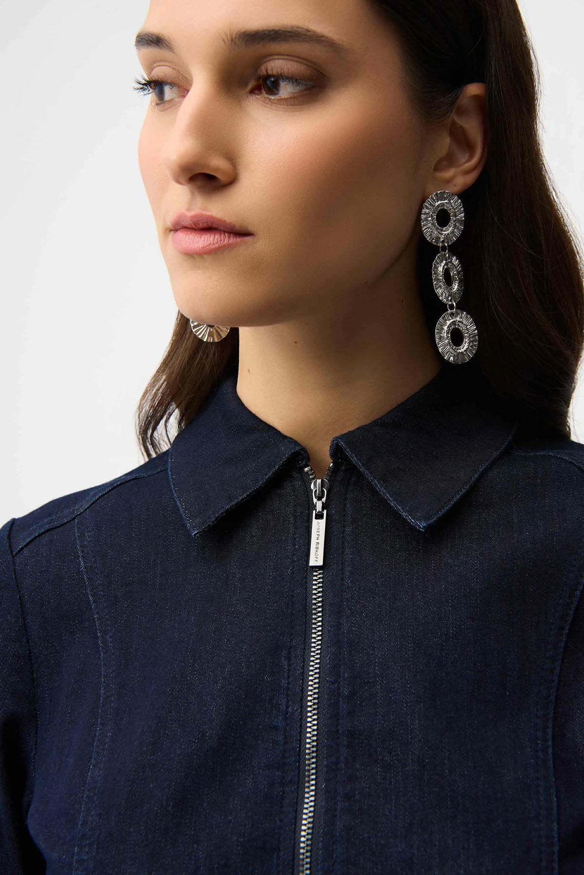 Woman wearing a indigo denim  dress with a belt on a white background