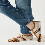 person wearing leopard and mesh sneakers on white background 