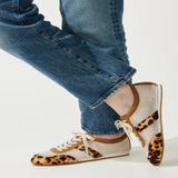 person wearing leopard and mesh sneakers on white background 