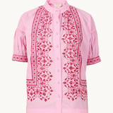 Pink blouse with intricate red embroidery on a white background