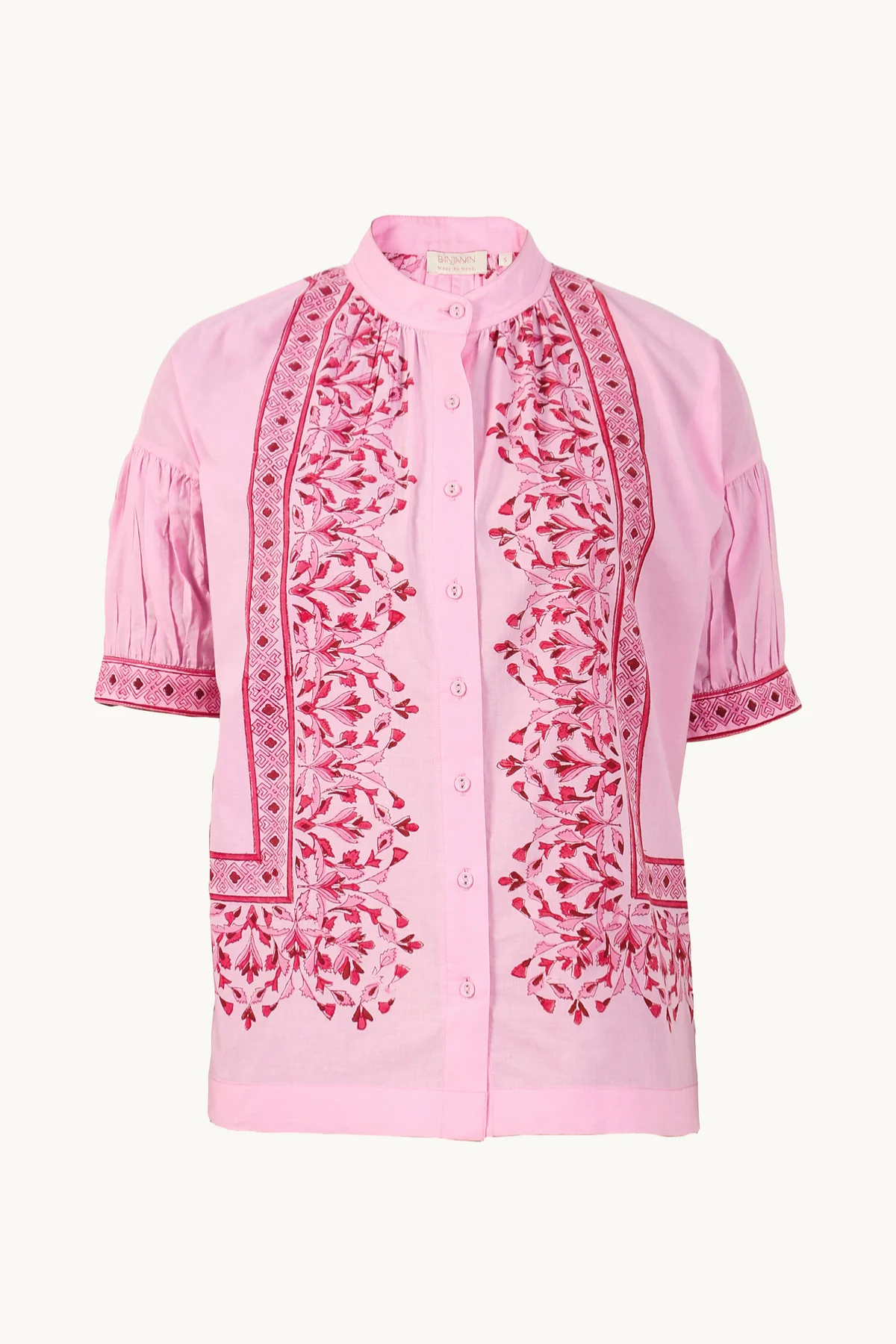 Pink blouse with intricate red embroidery on a white background
