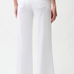 White pants worn by a person on a white background