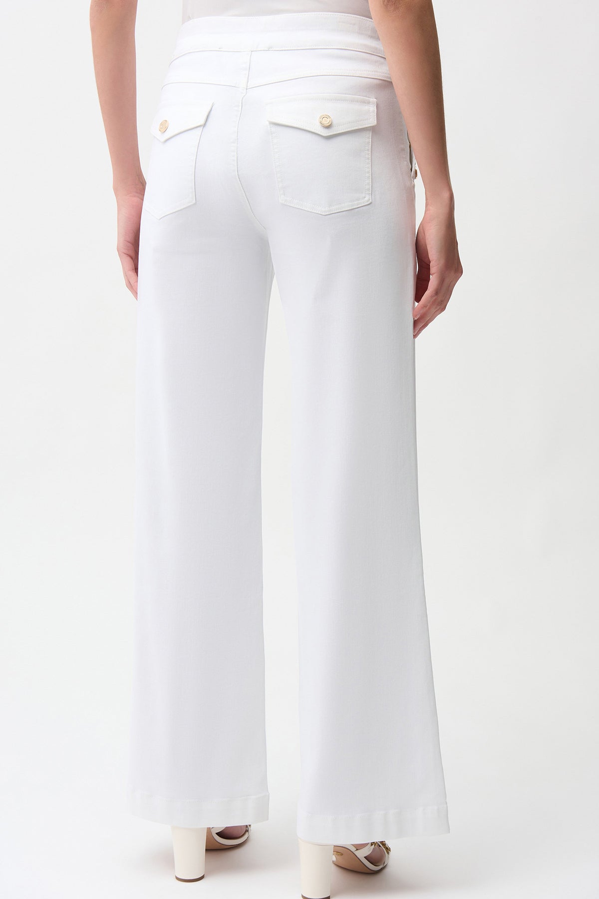 White pants worn by a person on a white background