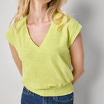 woman in vneck yellow tee on white background 