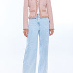 woman in blush pink tweed jacket and wide leg denim 