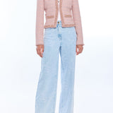 woman in blush pink tweed jacket and wide leg denim 