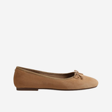 A single tan suede ballet flat shoe with a small matching fabric bow on the toe, shown in profile against a plain white background.