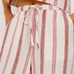 Striped outfit with a tie-waist design on a plain background