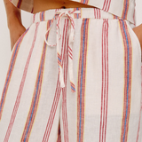 Striped outfit with a tie-waist design on a plain background