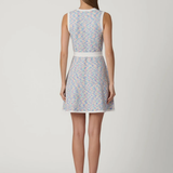 back of woman in multicolored dress on white background 