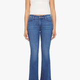 Woman wearing mid-wash flared jeans with a slim fit through the hip and gentle flare at the hem.