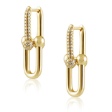A pair of gold huggie hoop earrings with pavé-set clear stones and polished gold bead accents, displayed on a clean white background with a soft reflection.