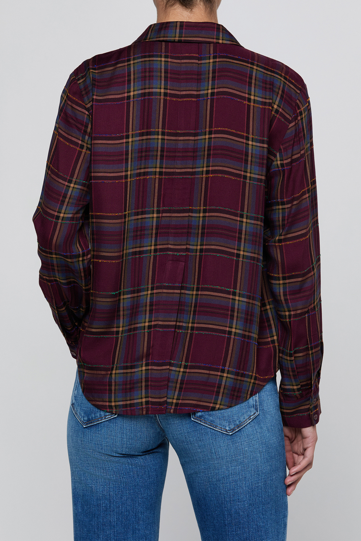 A person shown from the back wearing a long-sleeve plaid button-up shirt in deep burgundy with yellow, blue, and green stripes, paired with blue jeans, against a solid gray background.