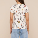 Person wearing a white t-shirt with cartoon character print and denim shorts on a beige background