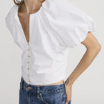 Blouse with dramatic voluminous sleeves styled with denim