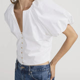 Blouse with dramatic voluminous sleeves styled with denim