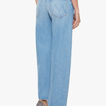 Light blue jeans worn by a person on a white background