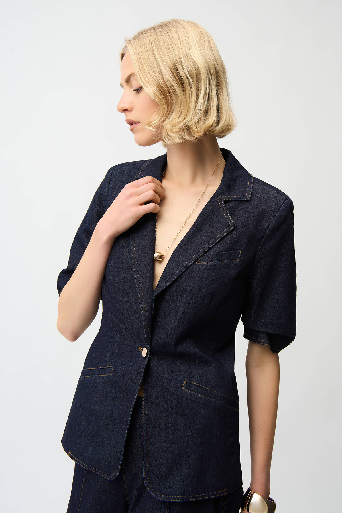 Woman wearing a navy blazer on a white background
