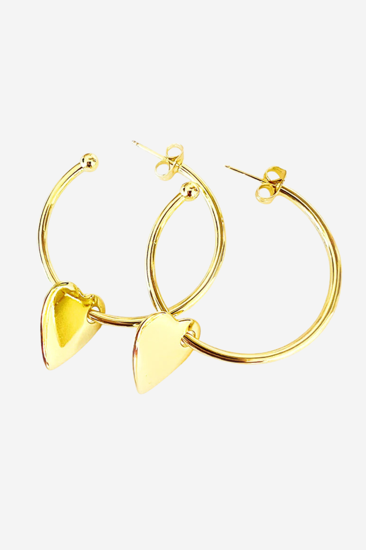 A pair of gold hoop earrings with dangling polished heart charms, displayed on a clean, light gray background.