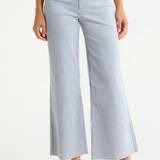 Blue and white striped wide-leg pants worn by a person on a white background