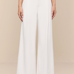 White wide-leg pants worn by a person on a beige background