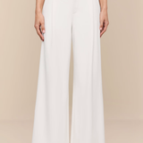 White wide-leg pants worn by a person on a beige background