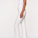 side view of woman in white denim on white background 