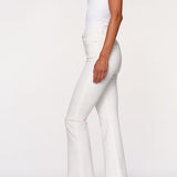 side view of woman in white denim on white background 