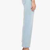 Light blue jeans worn by a person on a white background