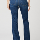 Blue jeans worn by a person on a white background