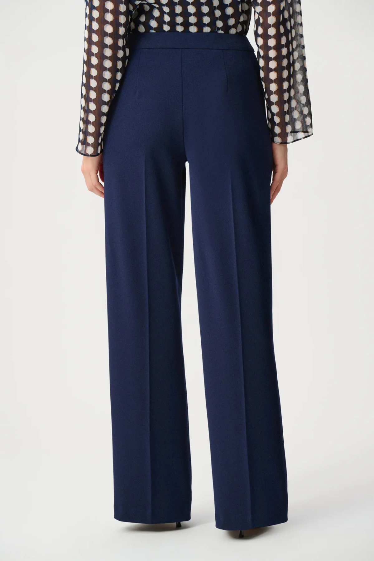 Model wearing navy scuba crepe pull-on wide-leg pants.