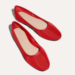 Pair of red flats on a white background