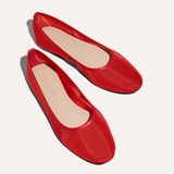 Pair of red flats on a white background