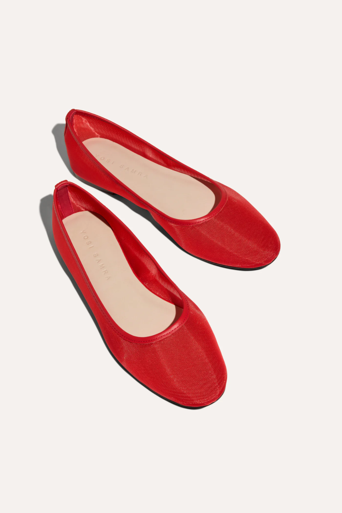 Pair of red flats on a white background