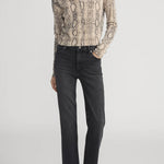 Cashmere cardigan with subtle snake pattern, styled with dark denim