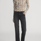 Cashmere cardigan with subtle snake pattern, styled with dark denim