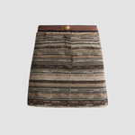 A mini skirt with a textured, woven horizontal stripe pattern in shades of brown, beige, and gray, featuring a contrasting dark brown waistband with a single gold button.