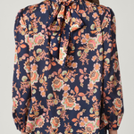 Woman wearing a floral blouse with a plain background