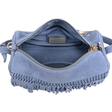 A dusty blue suede crossbody bag with gold-tone hardware and fringe detailing along the bottom edge, shown open against a plain white background.