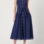 Model wearing a sleeveless midi dress with a fitted bodice and feminine, timeless silhouette.