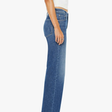 Person wearing blue jeans and a white top on a white background