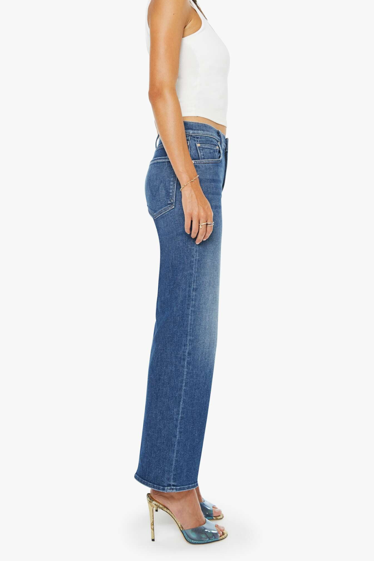 Person wearing blue jeans and a white top on a white background