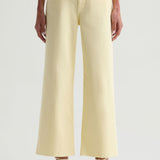 Light yellow jeans worn by a person on a white background