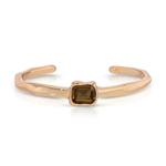 A slim, open cuff bracelet in polished rose gold with a central square-cut smoky brown gemstone, shown on a clean white background.