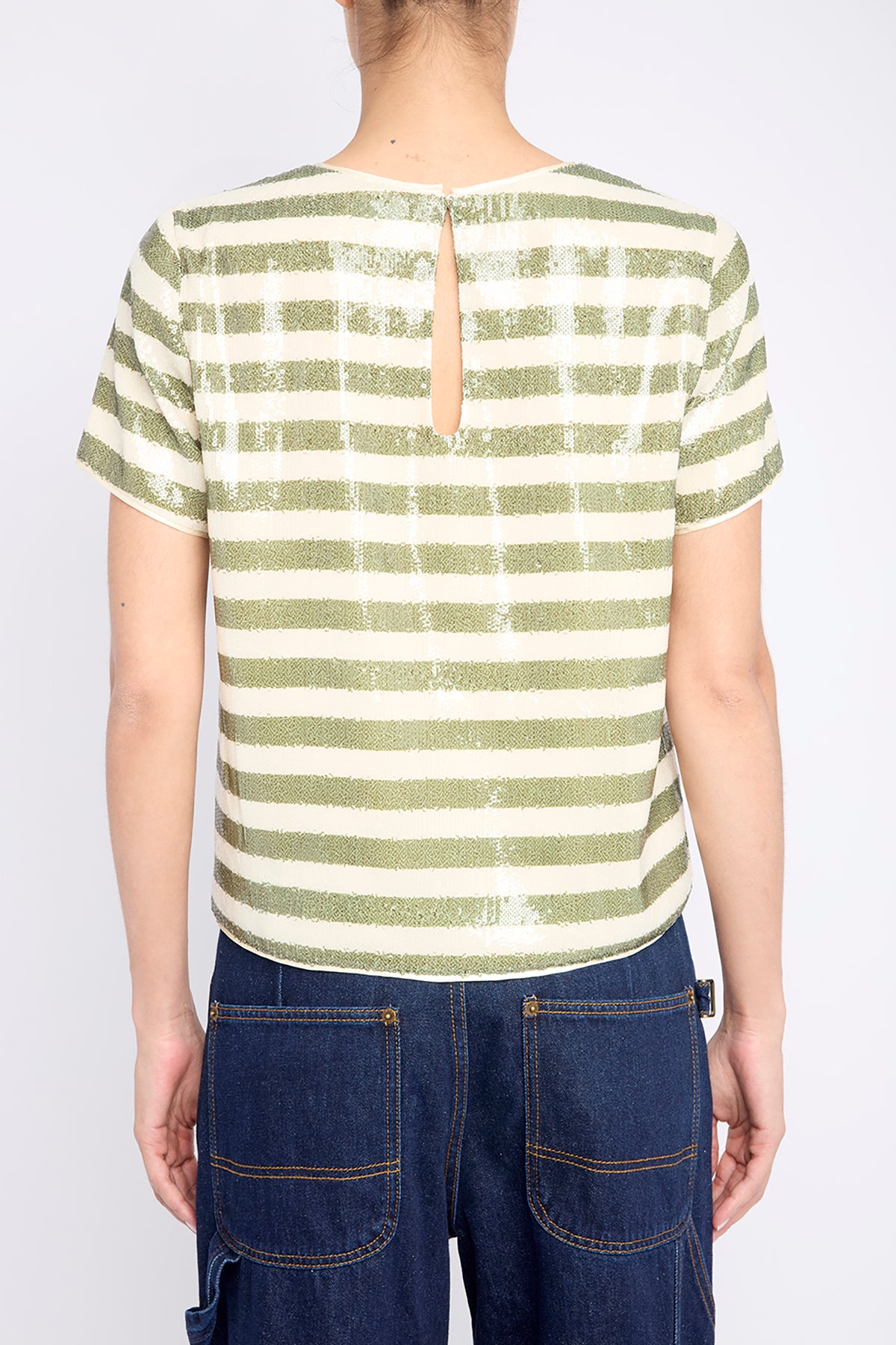 Striped top with subtle sequin detailing, styled for evening wear