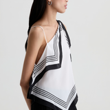 Model wearing a contemporary sleeveless printed top with a relaxed, flattering silhouette.