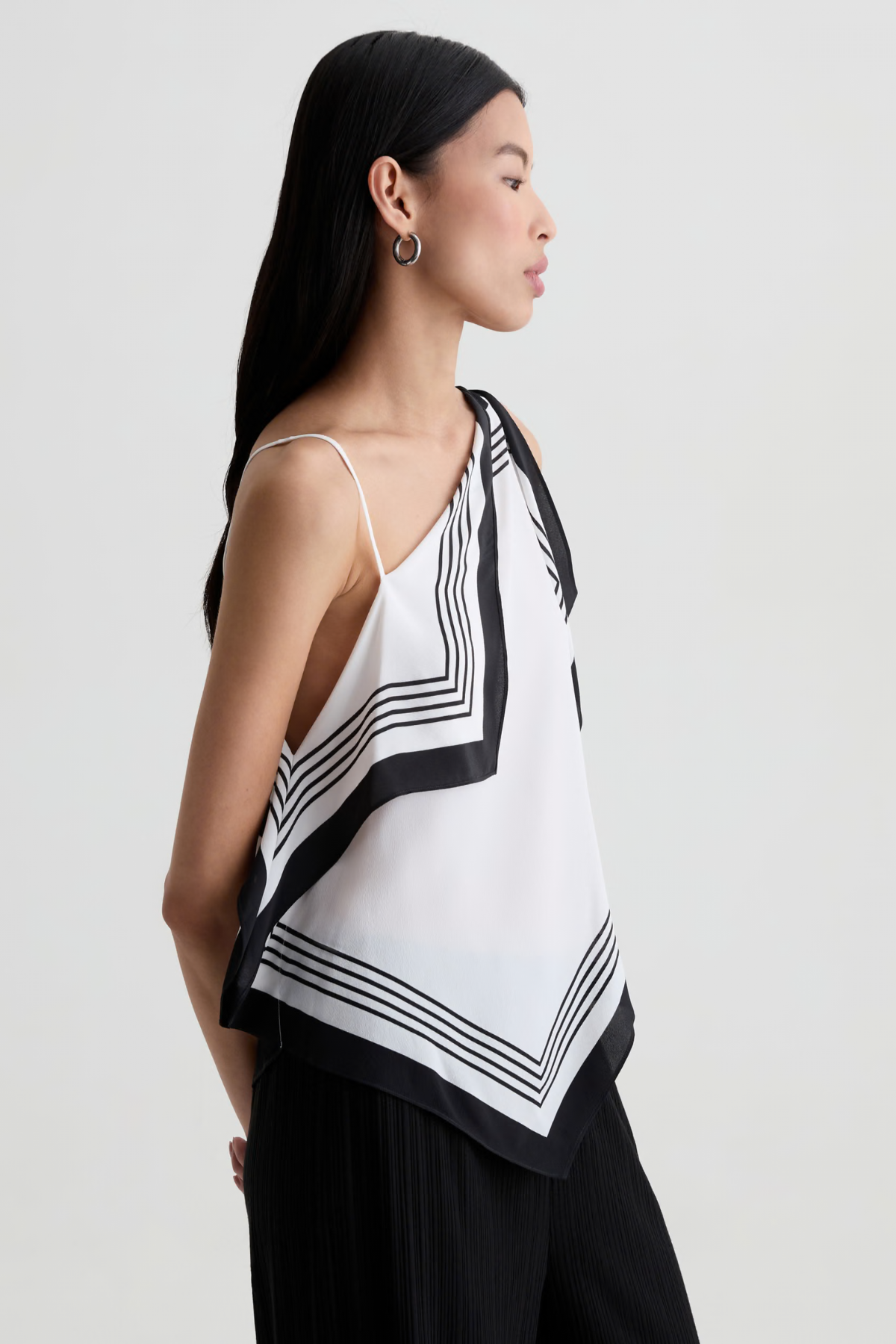 Model wearing a contemporary sleeveless printed top with a relaxed, flattering silhouette.
