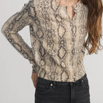 Cashmere cardigan with subtle snake pattern, styled with dark denim