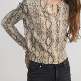 Cashmere cardigan with subtle snake pattern, styled with dark denim